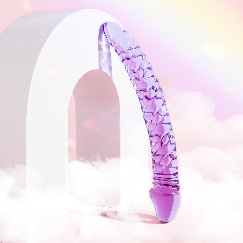 Curved purple glass ridged pleasure wand with thicker Fallic head and tapered end.  Pictured on pink background with a white arch and clouds.