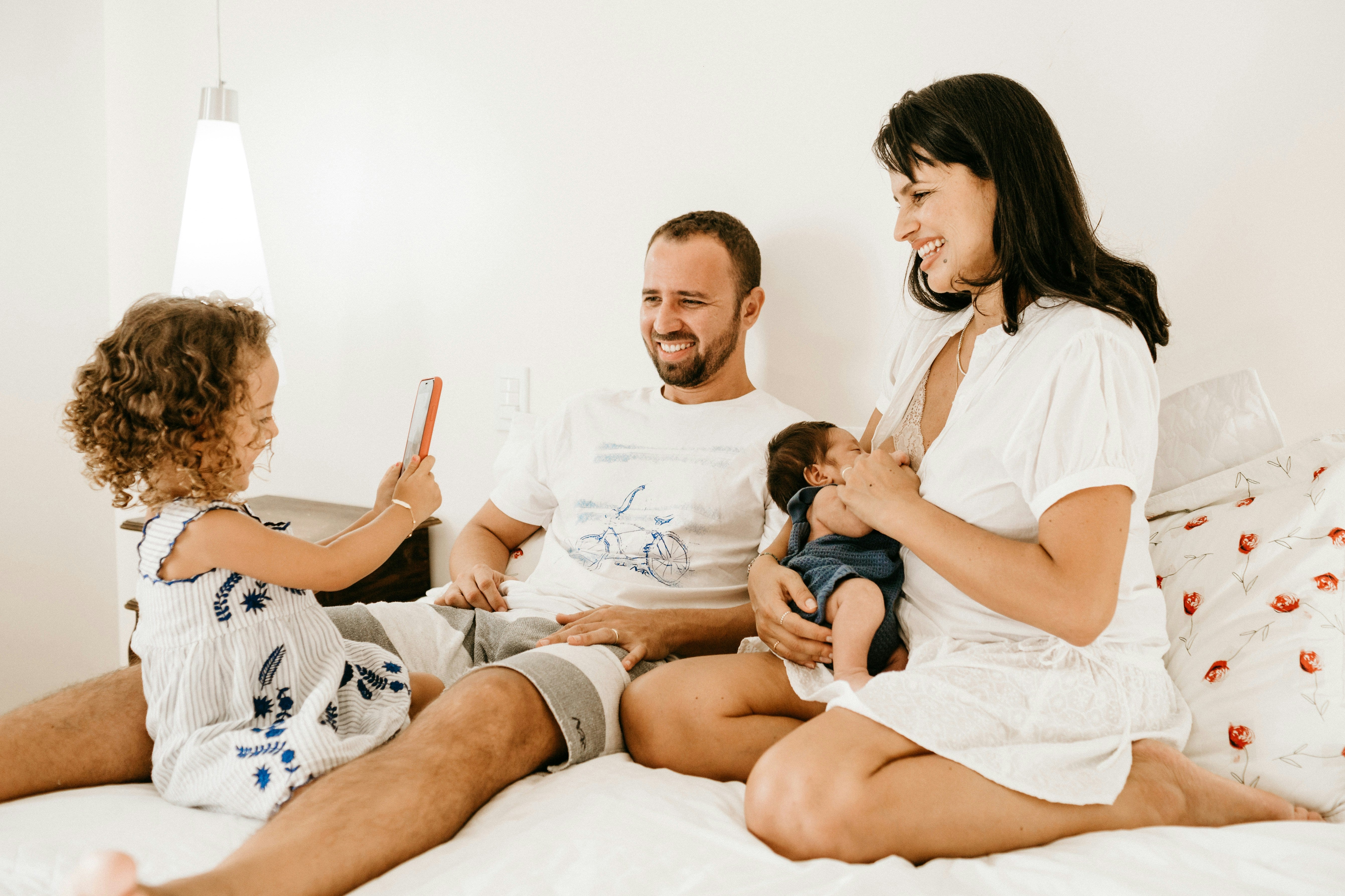 Dad and mom with toddler and nursing baby.