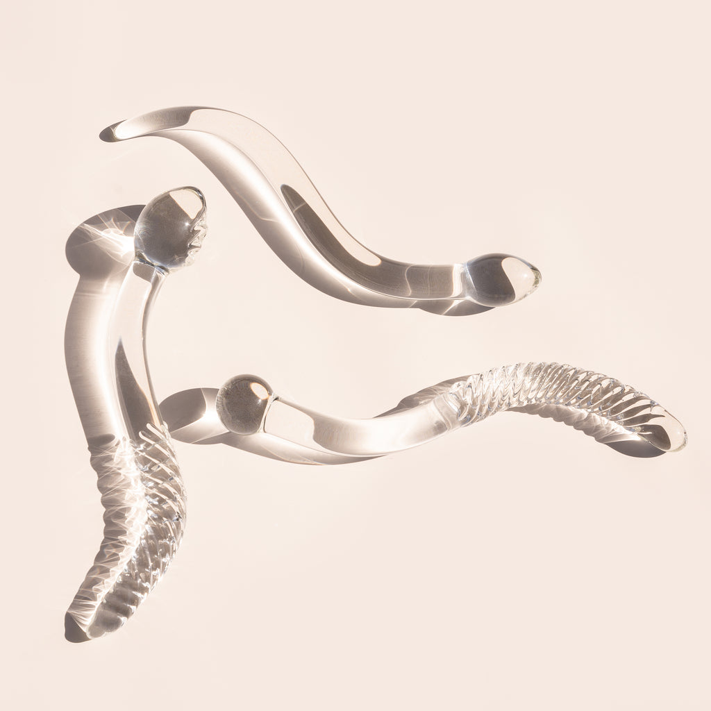 3 Clear cervix serpent pleasure wands showing the different variations between 1.0, 2.0 and 3.0 design. Glass pleasure wand designed for pelvic dearmouring, massage and self pleasure.