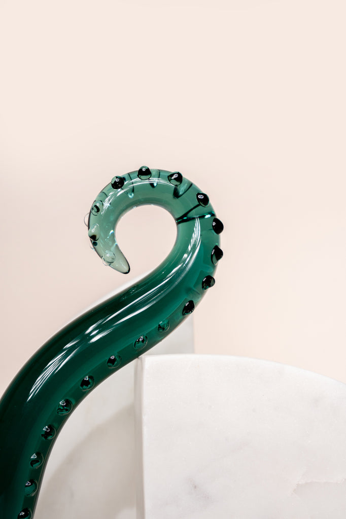 Dark green coloured glass pleasure wand (Octopussy). Pictured on white background with marble coloured arch blocks.