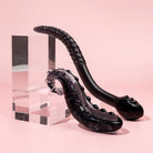 Midnight Black Ink colour Sacred squirter and Cervix Serpent glass pleasure wants both pictured on pink background and acrylic blocks.